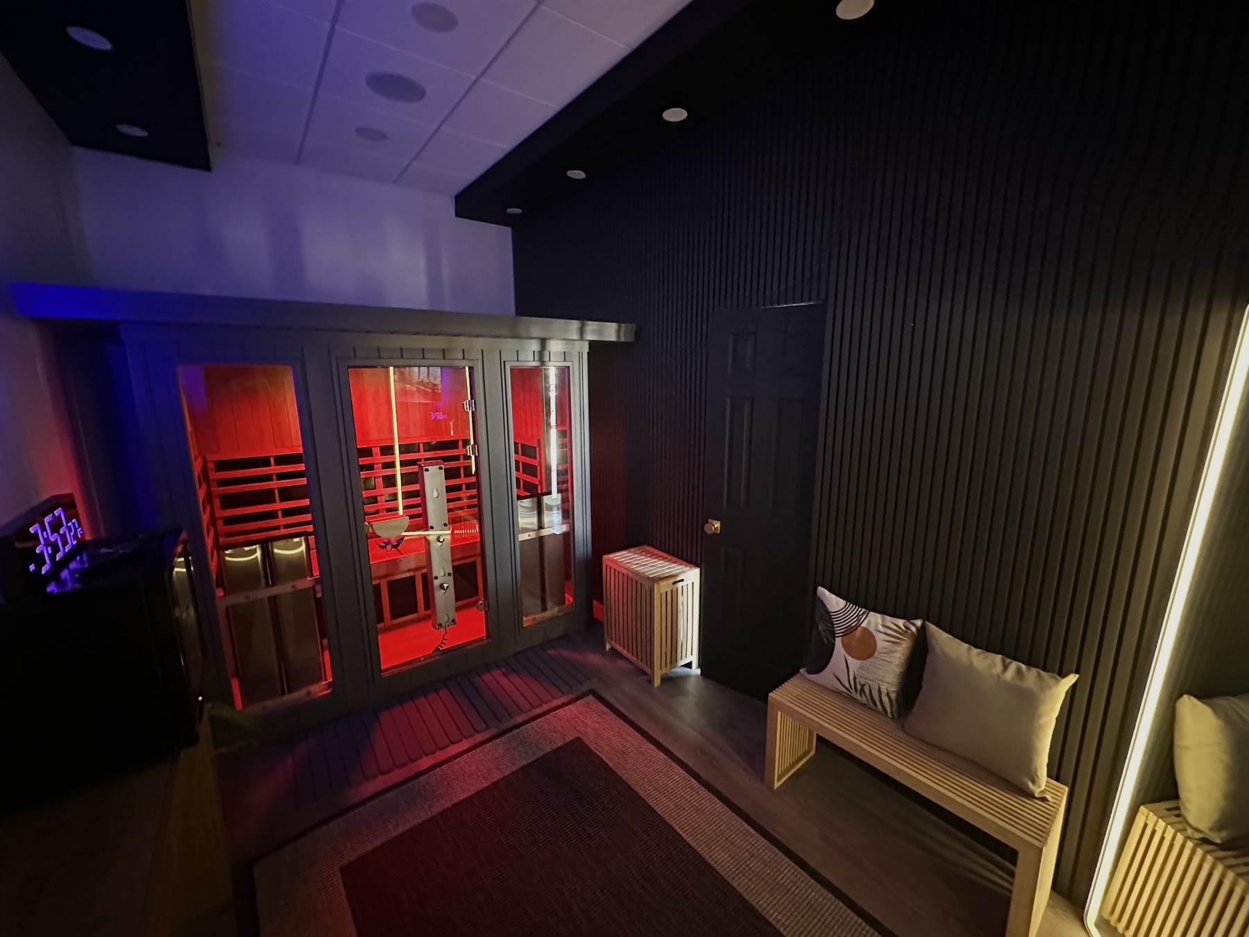 Infrared sauna cabin glowing red in a private Sauna House suite